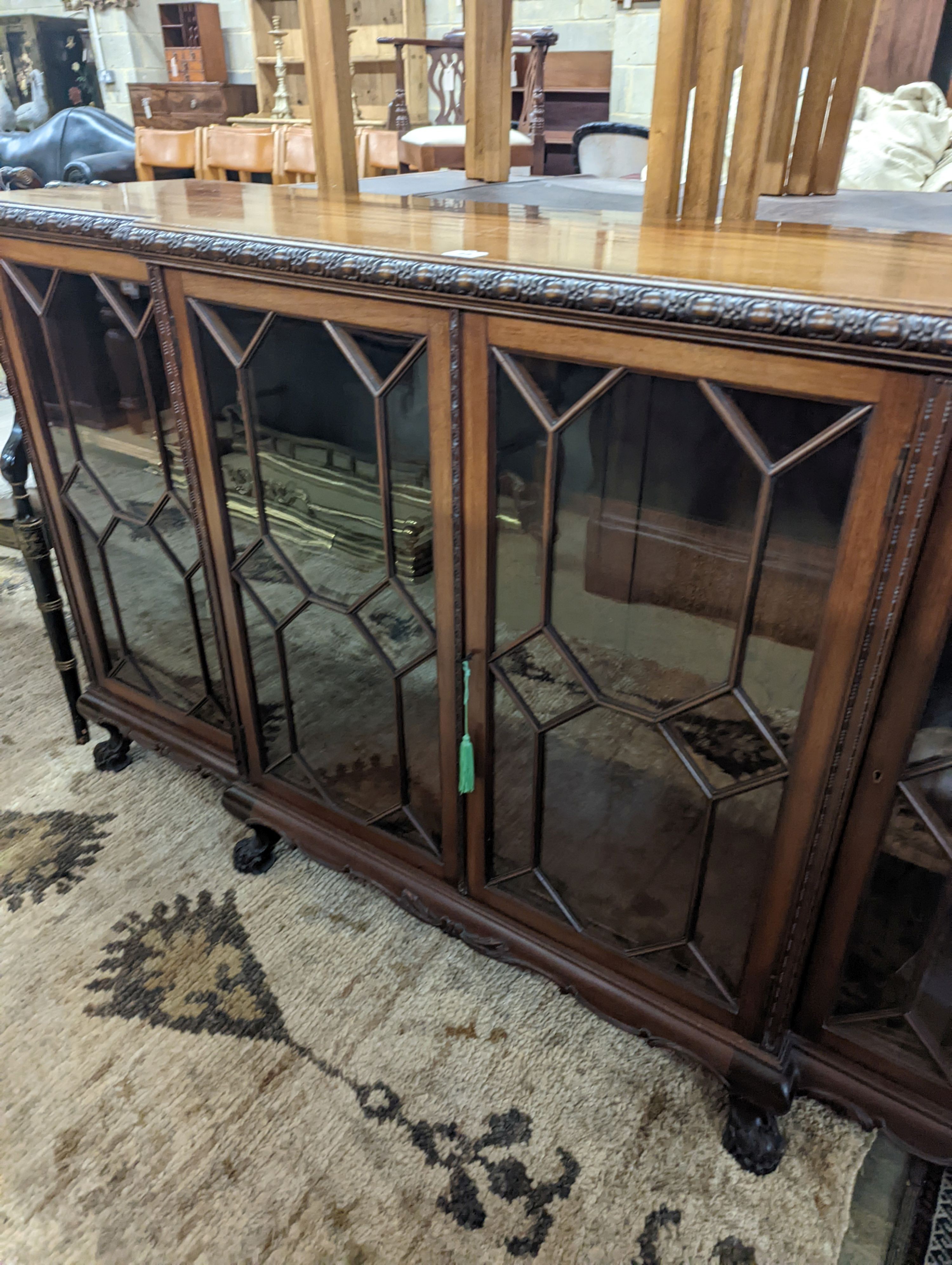 A 1920's Chippendale revival glazed mahogany break front dwarf cabinet, width 160cm, depth 43m, height 88cm